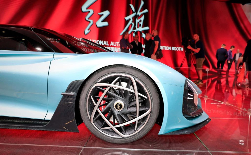 Futuristic Hongqi S9 supercar light blue profile with geometric wheels on red auto show backdrop Wallpaper