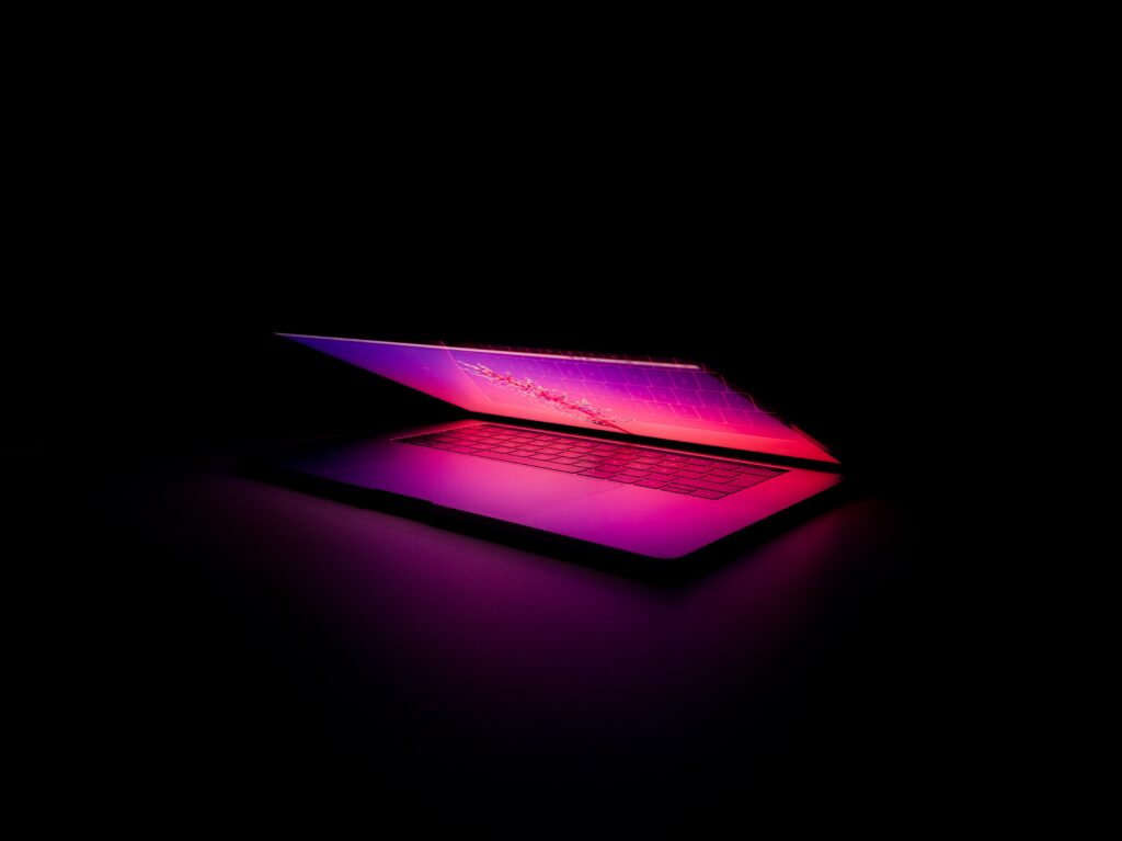 Futuristic Laptop Wallpaper: Glowing Keyboard & Gradient Light Background