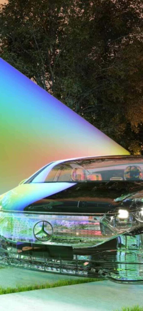 Reflective Mercedes-Benz S-Class with vibrant multicolored light showcasing sleek luxury design outdoors Wallpaper