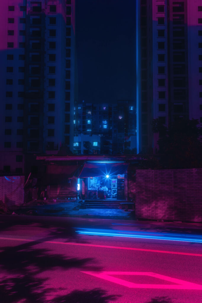 Vibrant Neon City Scene: Futuristic Shack in Pink & Blue Glow Wallpaper