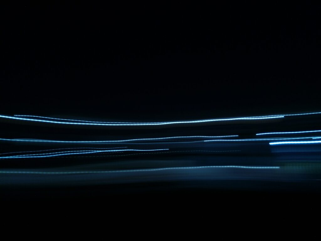 Futuristic Neon Lines Wallpaper on Black Background - Modern Design