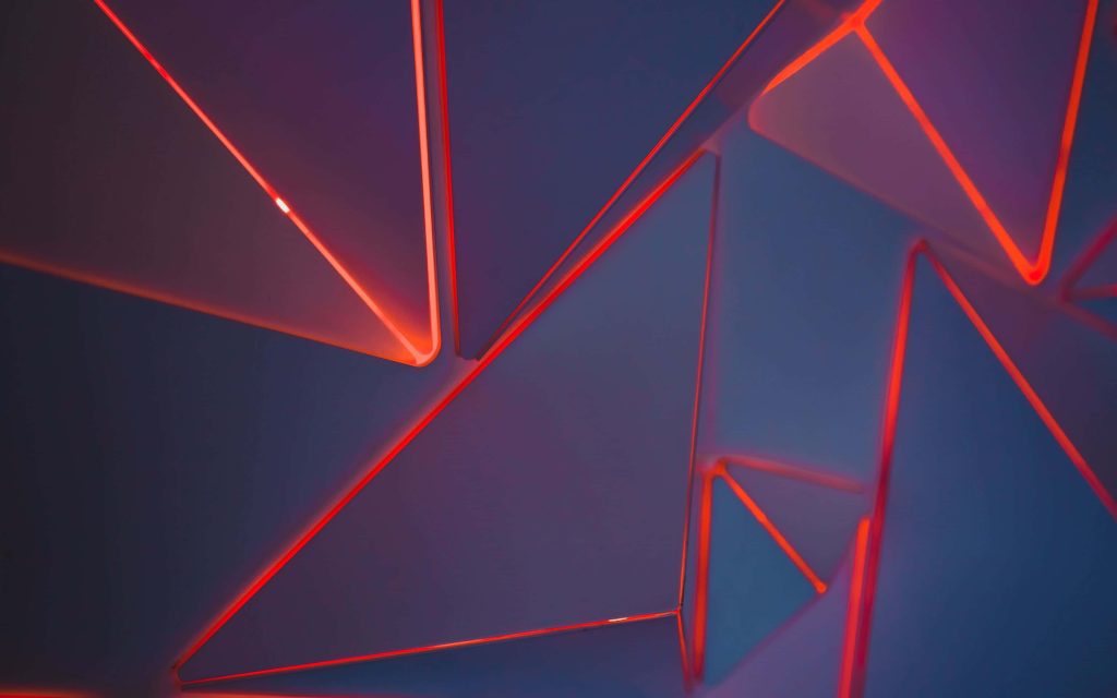 Abstract wallpaper with geometric panels and vibrant neon red LED lighting high-tech background
