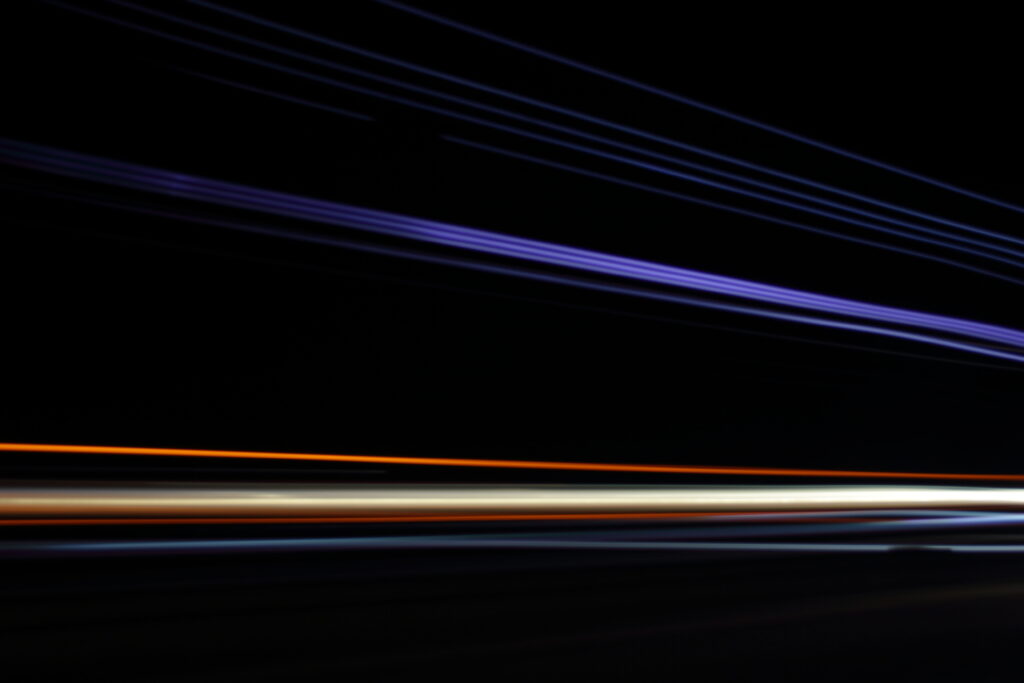 Dynamic Neon Lines Wallpaper: Vibrant Stripes on Dark Background