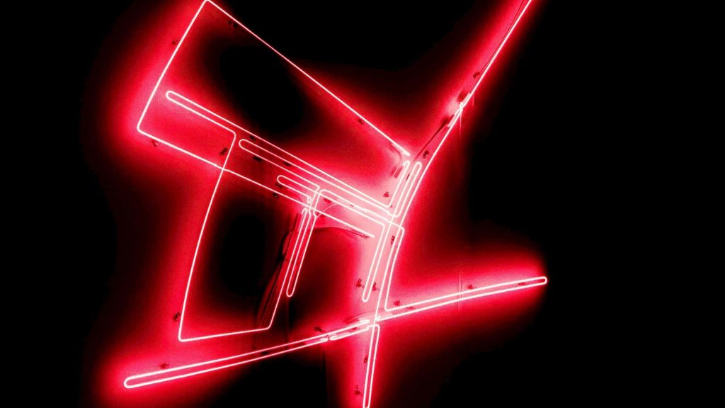 Abstract red neon lines forming a futuristic geometric shape on a black minimalist wallpaper background
