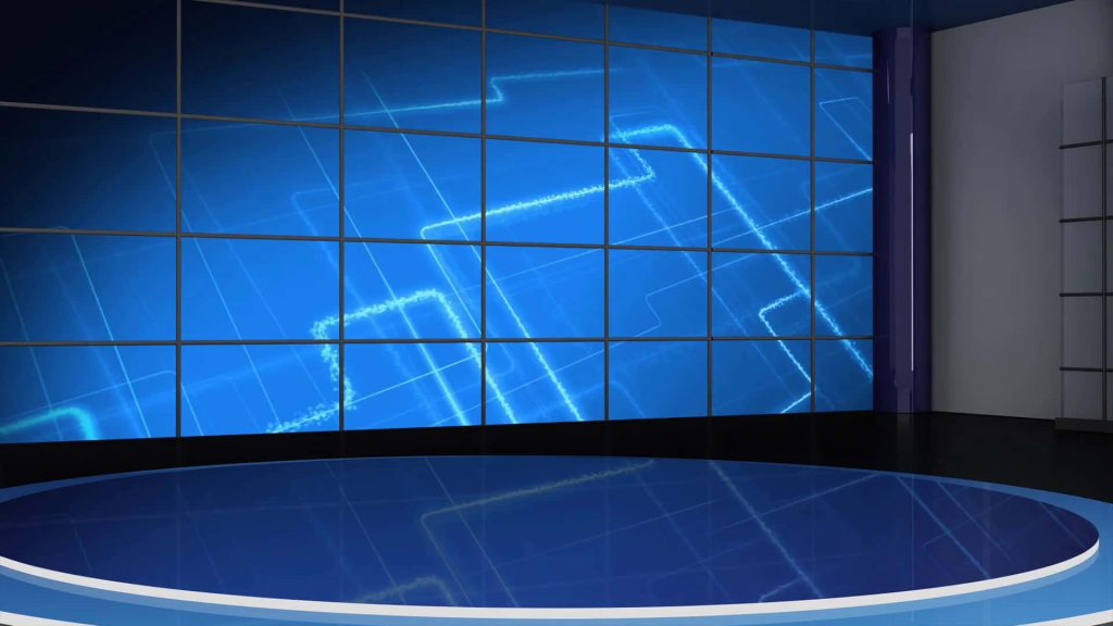 Futuristic virtual news studio with glowing blue geometric video wall and reflective circular stage Wallpaper