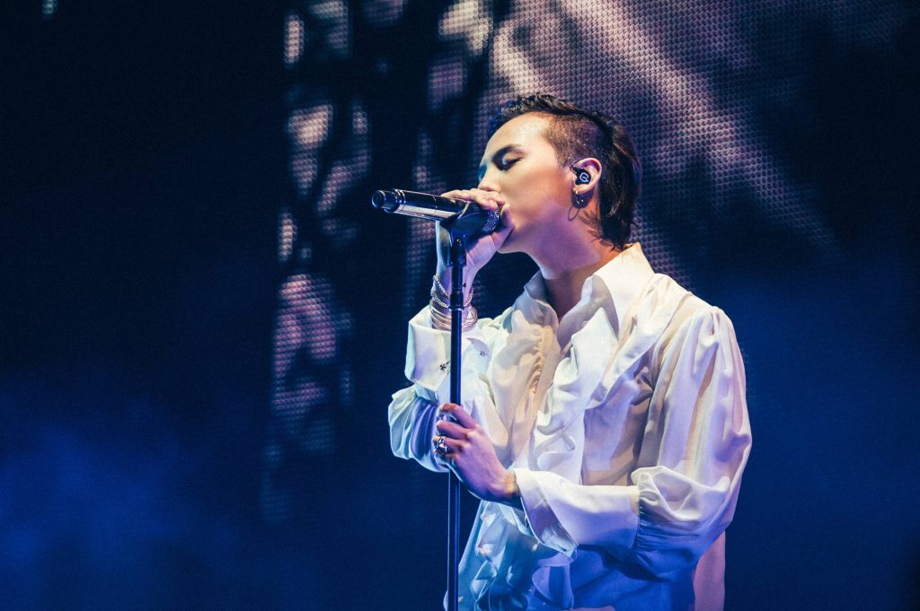G-Dragon intense K-pop concert mid-performance white ruffled shirt blue stage lighting wallpaper