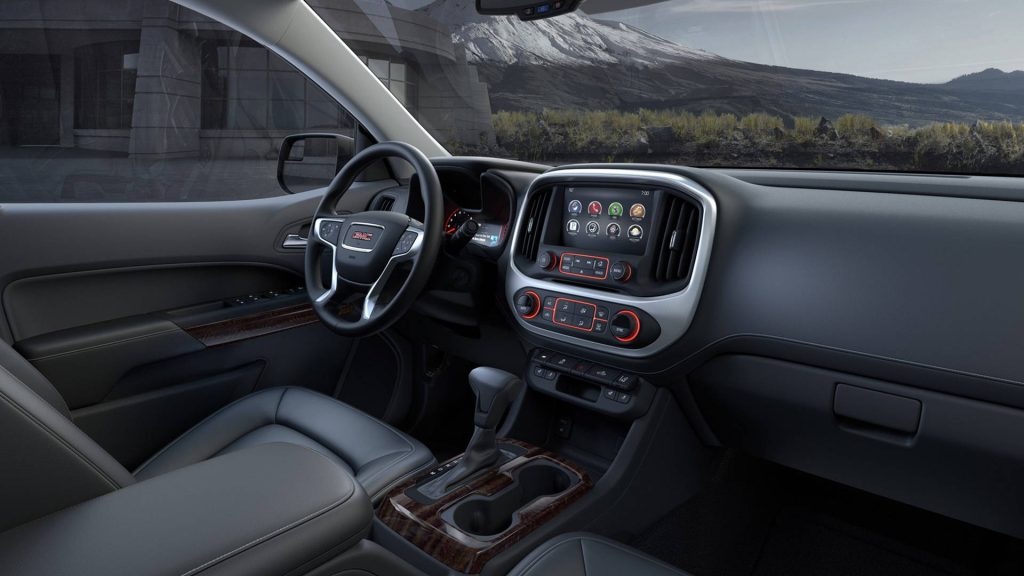 GMC Canyon interior with premium leather seats wood grain accents and touchscreen display wallpaper