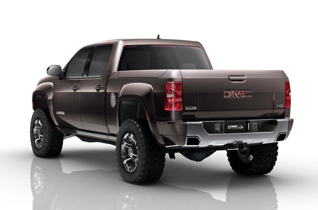 Metallic brown GMC Sierra HD All Terrain pickup rear view studio wallpaper background high-res