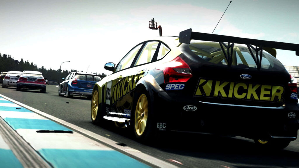 Dynamic Grid Autosport racing car wallpaper with 'KICKER' sponsorship on racetrack