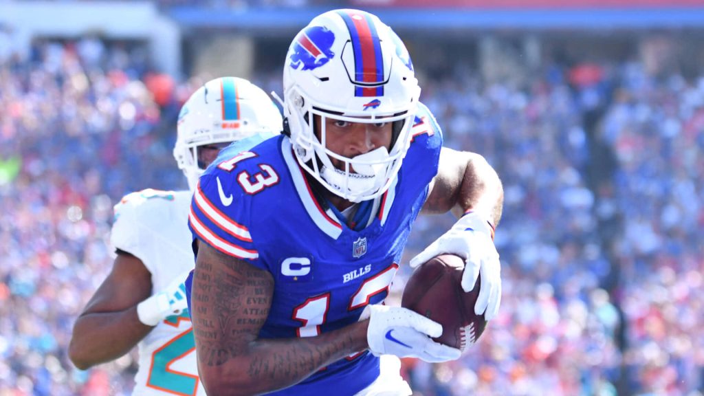 Buffalo Bills Gabe Davis #13 runs with football chased by Miami Dolphins defender NFL action wallpaper