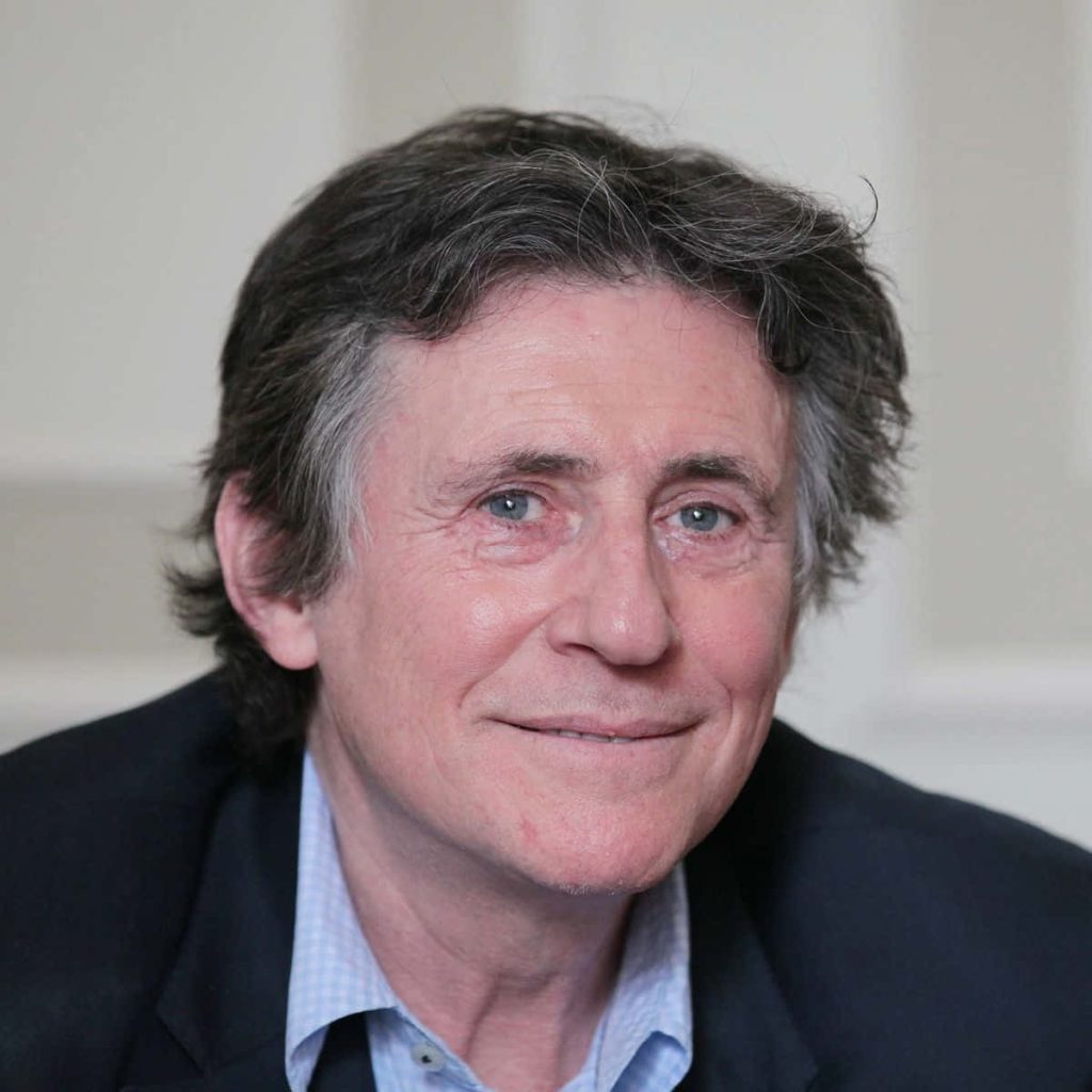 Gabriel Byrne professional portrait smiling warm neutral background classic lighting wallpaper
