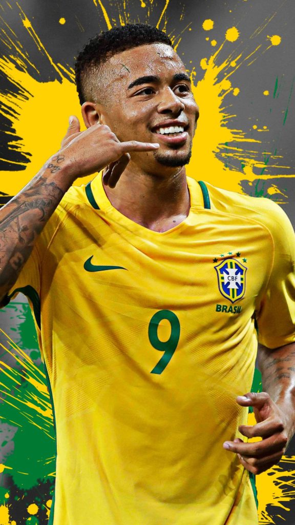 Gabriel Jesus in yellow Brazil jersey making phone call gesture with green yellow splatter background Wallpaper