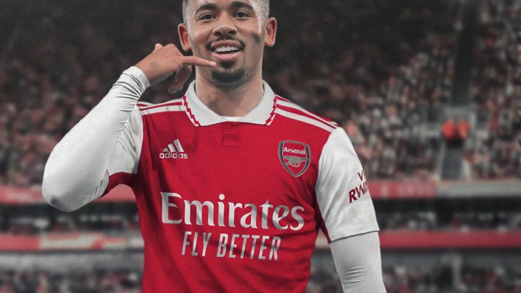 Arsenal striker Gabriel Jesus in red kit celebrates with phone call gesture stadium background Wallpaper