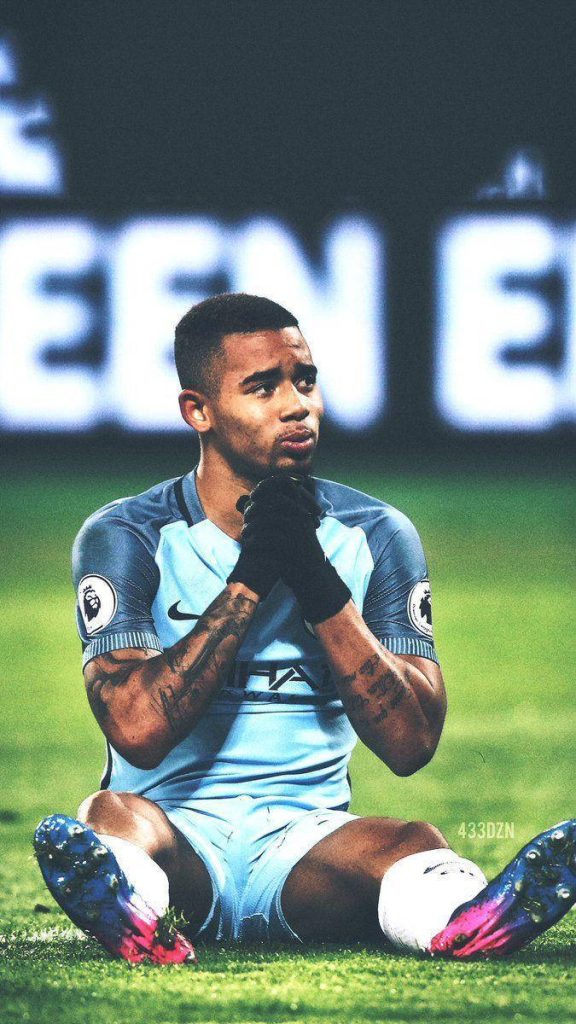 Gabriel Jesus Manchester City focused seated on pitch intense mood high contrast football wallpaper