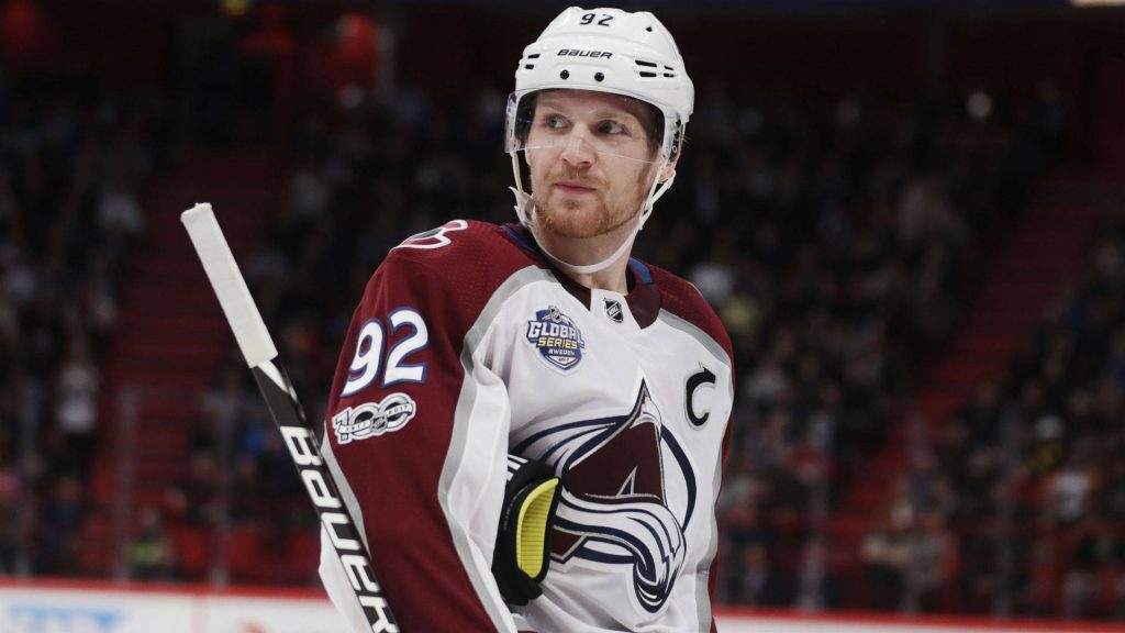 Gabriel Landeskog Colorado Avalanche captain focused in NHL jersey on ice blurred arena background Wallpaper