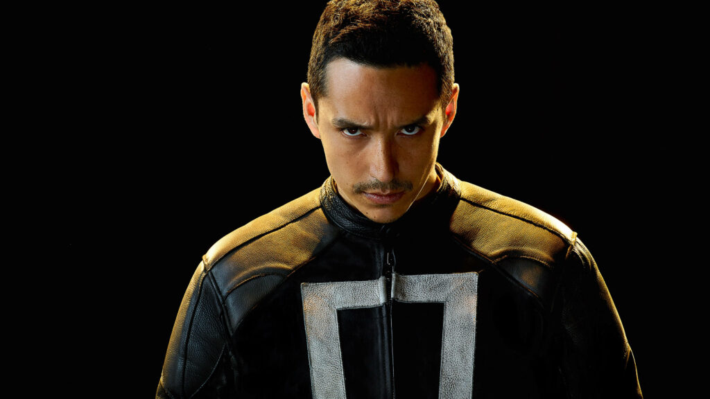 Gabriel Luna as Ghost Rider in black leather jacket with intense look dark background wallpaper