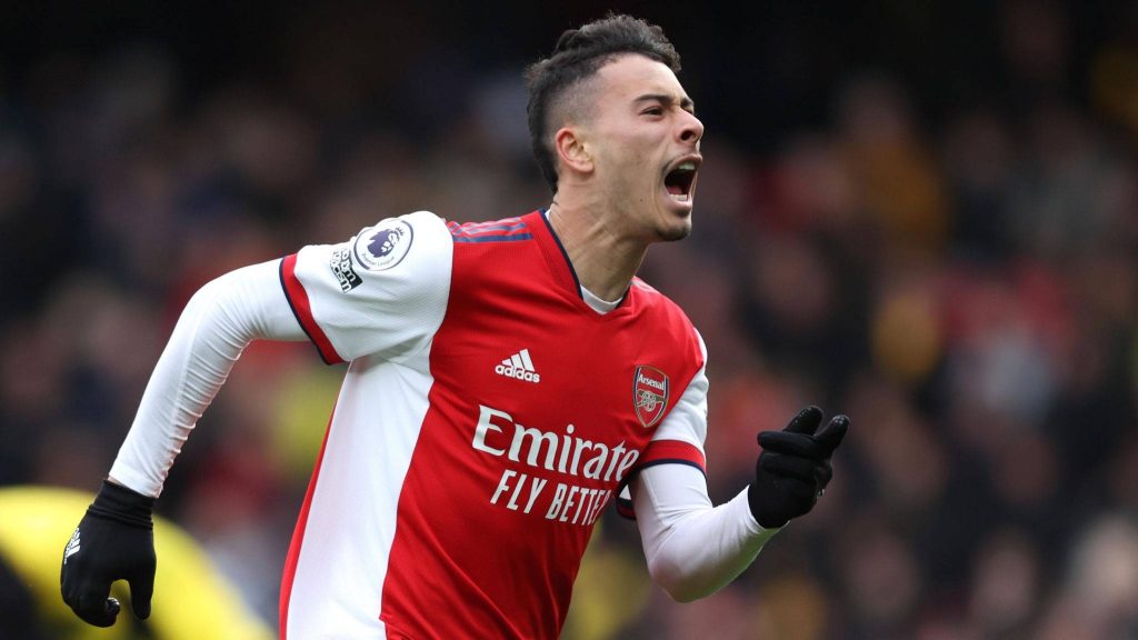 Arsenal forward Gabriel Martinelli in red white kit shouting mid-run with blurred stadium background Wallpaper
