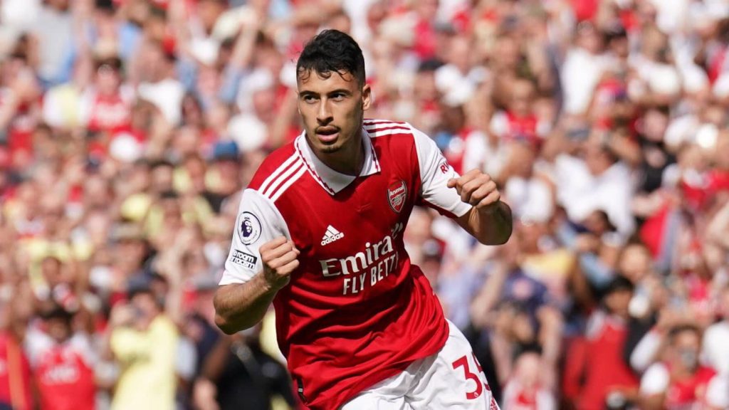 Gabriel Martinelli Arsenal goal celebration wallpaper red white kit vibrant stadium crowd