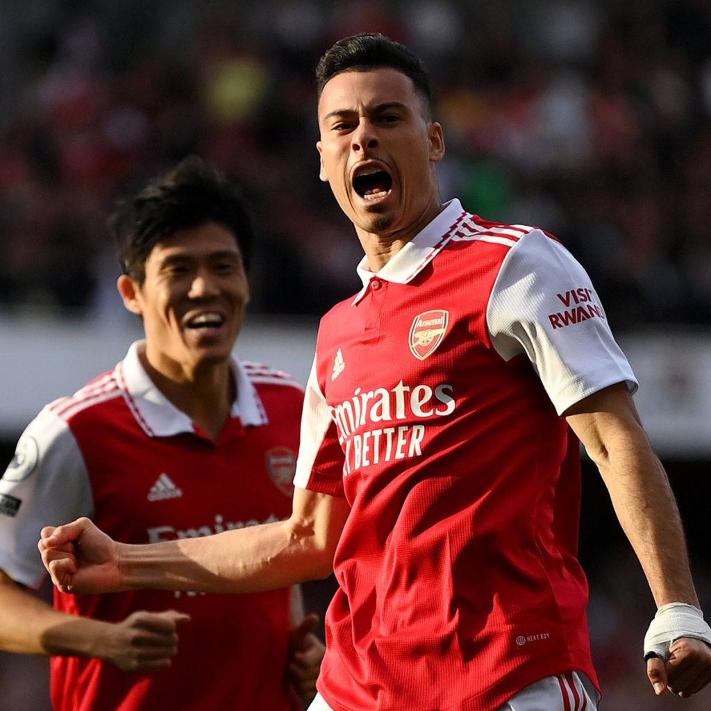 Gabriel Martinelli celebrating Arsenal goal with Takehiro Tomiyasu in red and white kit wallpaper