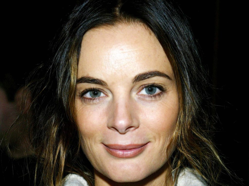 Gabrielle Anwar close-up portrait with striking blue grey eyes wavy brown hair dark background wallpaper