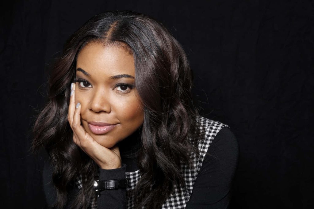 Gabrielle Union close-up portrait black turtleneck houndstooth vest confident elegant studio background Wallpaper