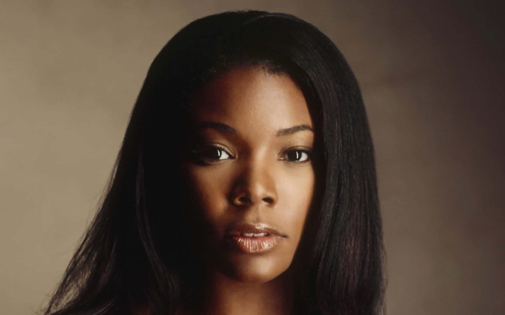 Elegant studio headshot of Gabrielle Union with soft lighting and warm neutral background Wallpaper
