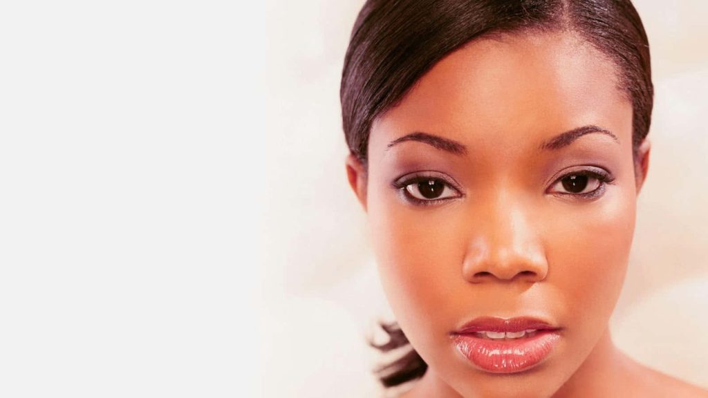 Gabrielle Union close-up portrait with glossy lips radiant high-key lighting elegant wallpaper background