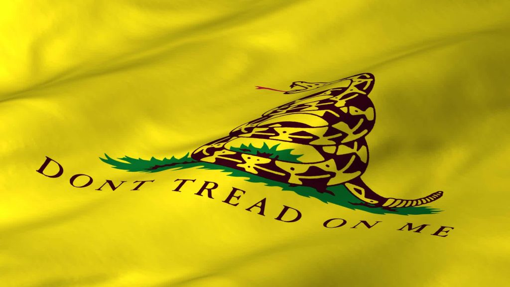 Gadsden Flag wallpaper with coiled rattlesnake and Dont Tread On Me motto on yellow fabric