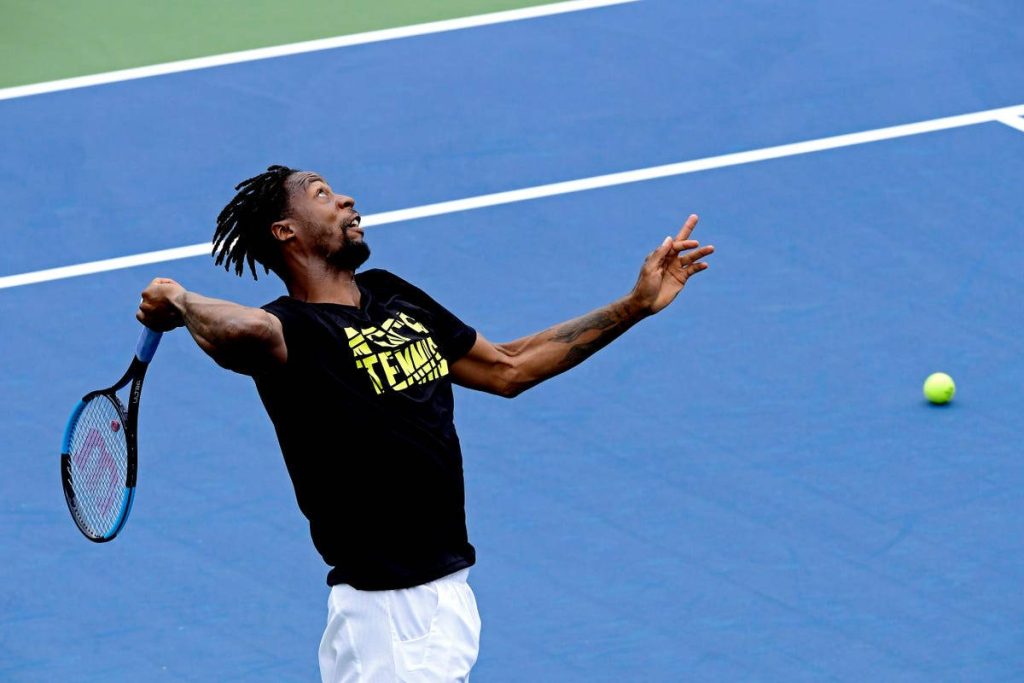 Gaël Monfils mid-swing on hard court tennis dynamic action shot vibrant sports wallpaper