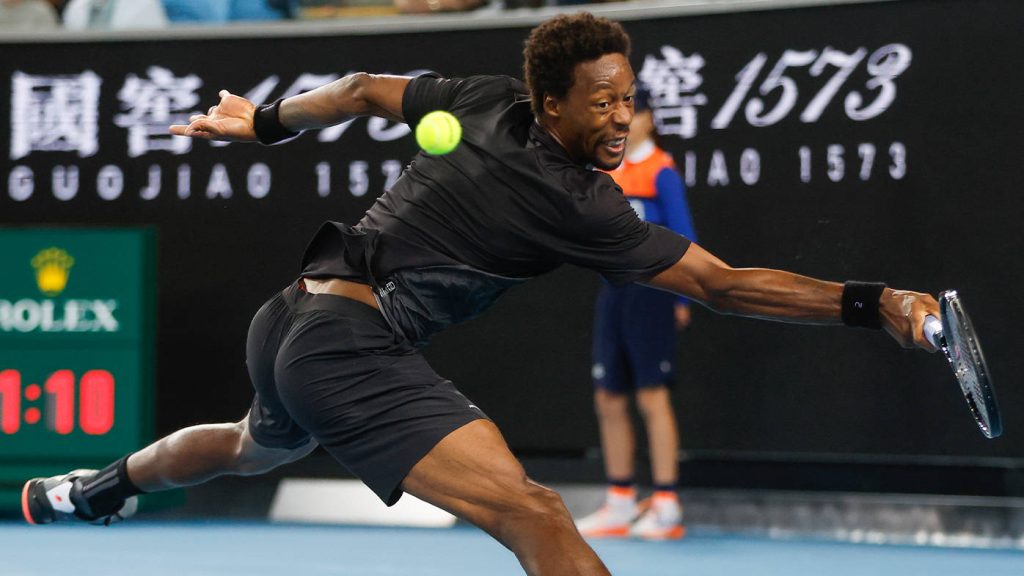 Gael Monfils mid-dive hitting tennis ball Australian Open black kit high-energy action shot Wallpaper