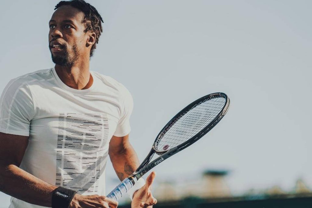 Gaël Monfils playing tennis outdoors with Artengo TR960 racket bright sunlight sports wallpaper