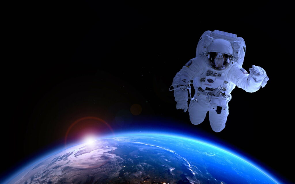Galactic Voyage: Captivating HD Wallpaper of Astronaut Exploring the Celestial Expanse