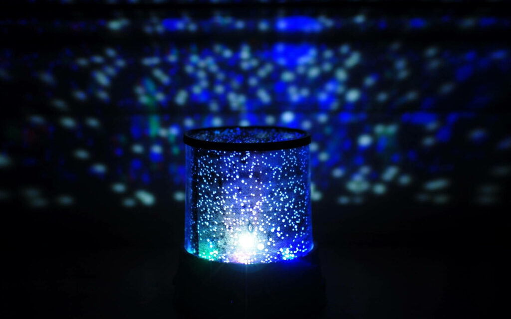 Enchanting Extraterrestrial Illumination: Captivating HD Light Background Showcasing a Colorful Galaxy with Radiant Blue, White, and Green Lights Against a Mysterious Dark Canvas Wallpaper
