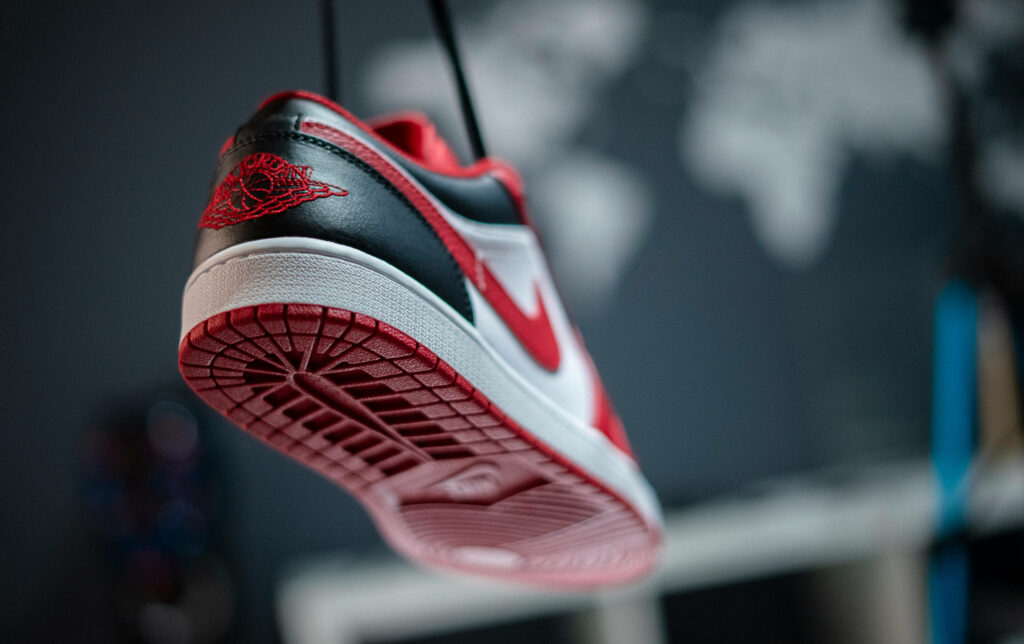 Hoop Ready: A Stunning HD Background Image Showcasing a Bold Red Nike Basketball Shoe Wallpaper
