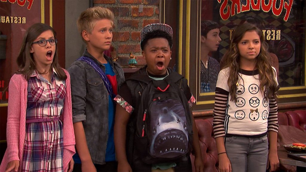Game Shakers team shocked in diner with Triple G's shark backpack vibrant Nickelodeon wallpaper