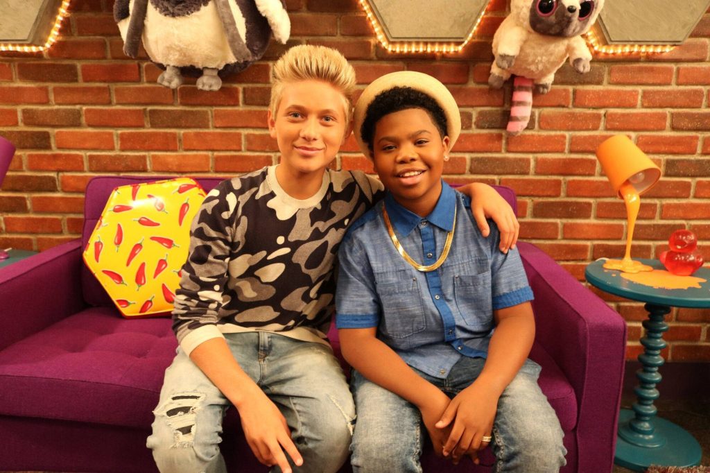 Game Shakers wallpaper with Jace Norman and Benjamin Flores Jr. on purple couch TV crossover background