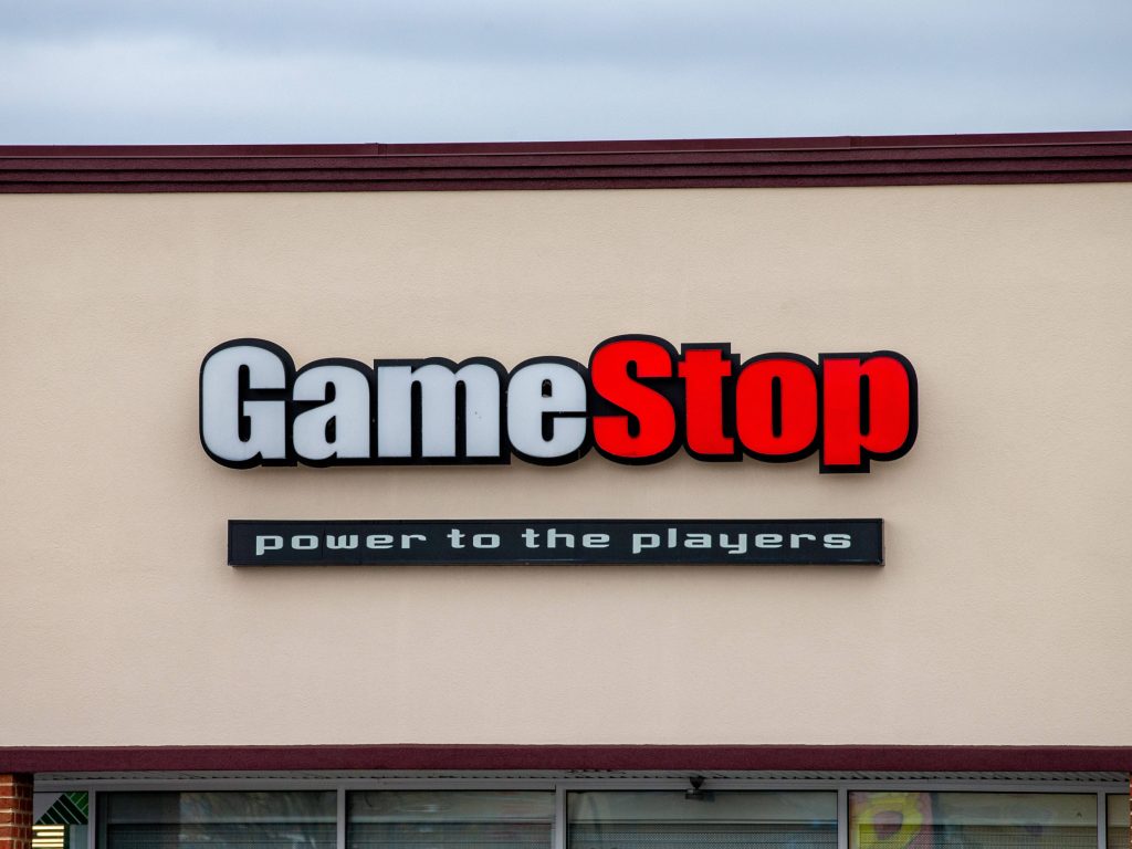 GameStop storefront with iconic red white logo and Power to the Players sign exterior wall Wallpaper
