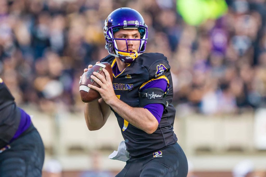 Gardner Minshew II in black purple ECU football uniform focused during game action wallpaper background