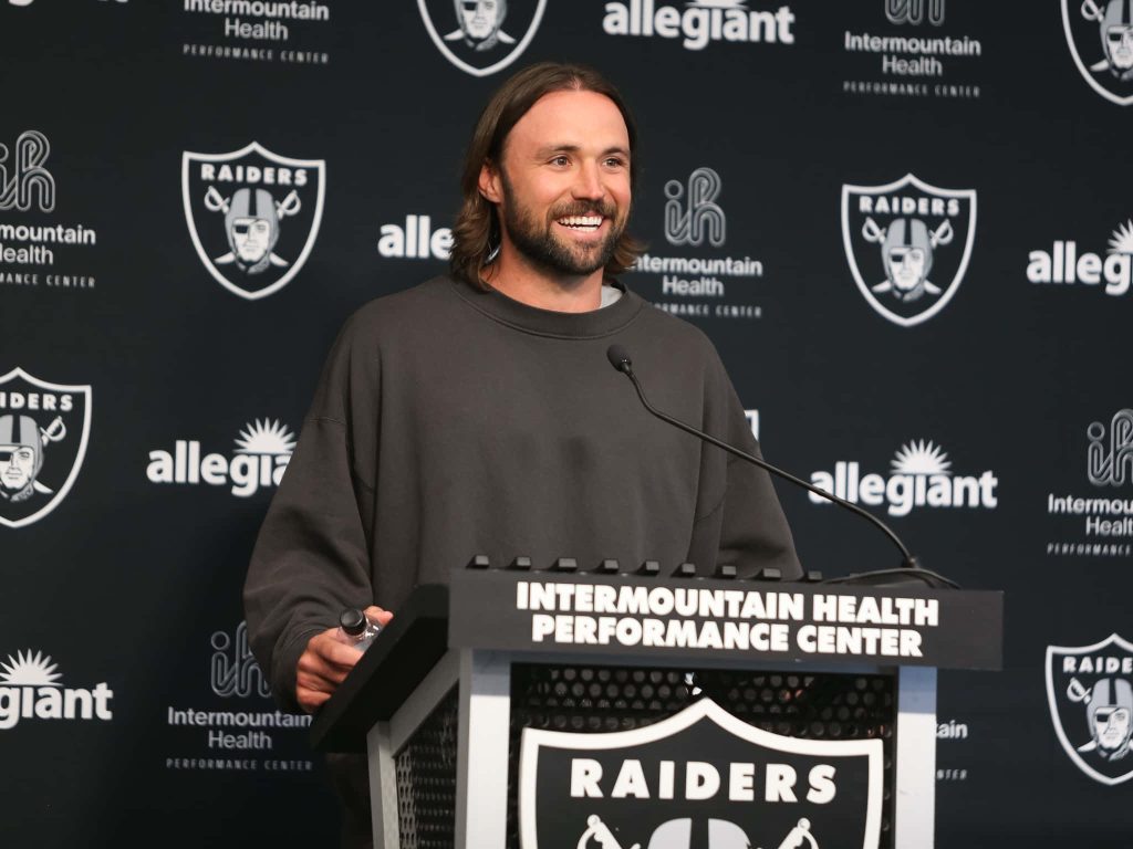 Gardner Minshew II NFL quarterback smiling at Las Vegas Raiders press conference podium in grey sweatshirt Wallpaper