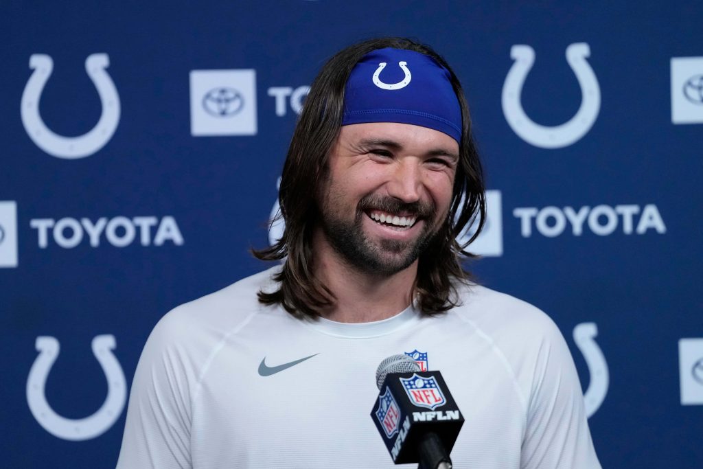 Gardner Minshew II smiling at Colts press conference in white shirt with NFL Network mic Wallpaper