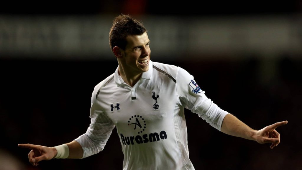 Gareth Bale in white Tottenham Hotspur kit smiling and pointing finger dark sports wallpaper background