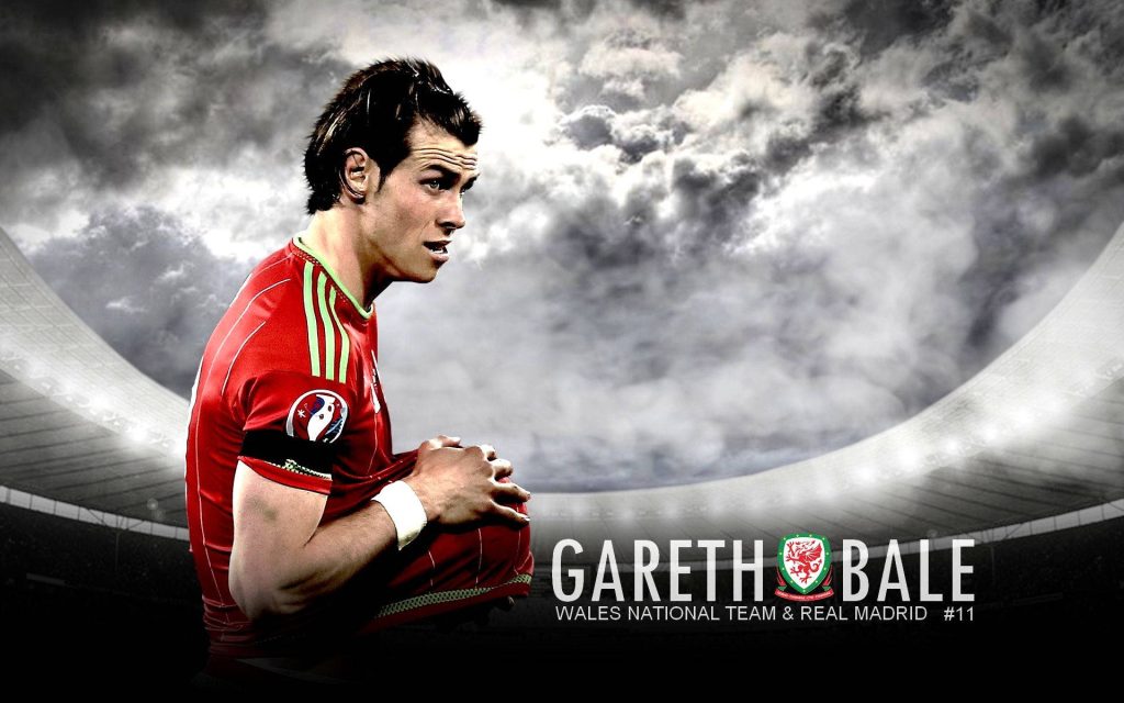 Gareth Bale in red Wales kit on stormy stadium background intense football sports wallpaper