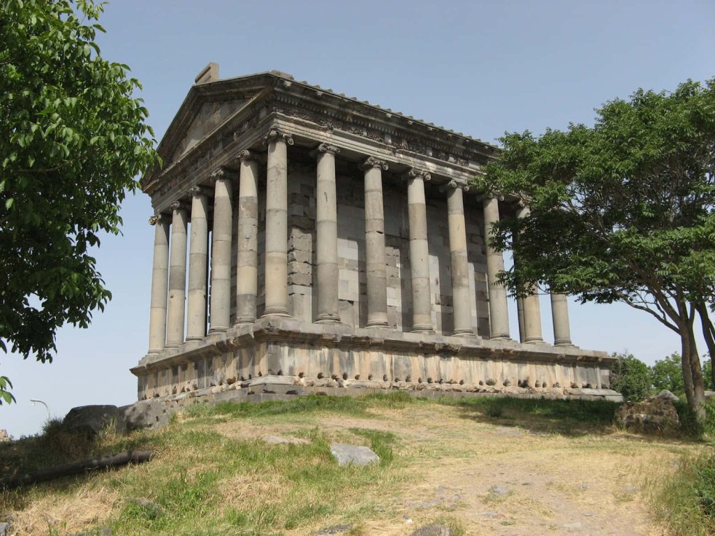 Garni Temple Armenia Hellenistic stone architecture with lush greenery and blue sky wallpaper