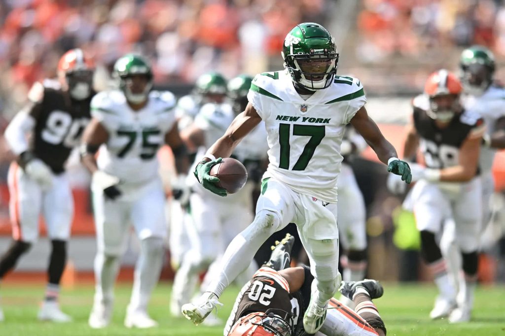 Garrett Wilson #17 New York Jets leaping over defender NFL game action wallpaper background