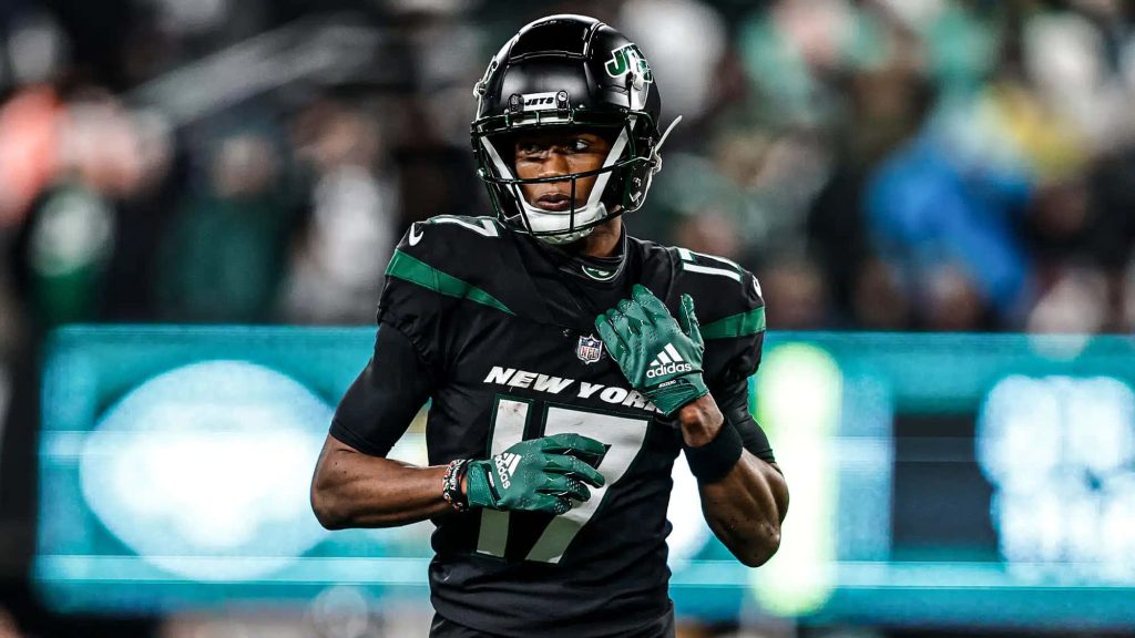 Garrett Wilson New York Jets in black uniform ready for action vibrant stadium sports wallpaper