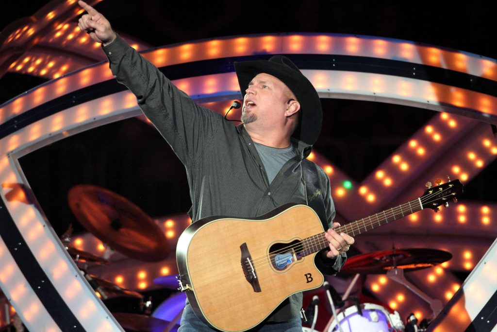 Garth Brooks live concert wallpaper acoustic guitar black cowboy hat warm stage lighting