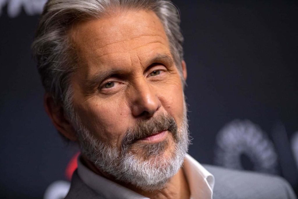 Close-up portrait of actor Gary Cole with salt-and-pepper hair intense gaze studio lighting Wallpaper