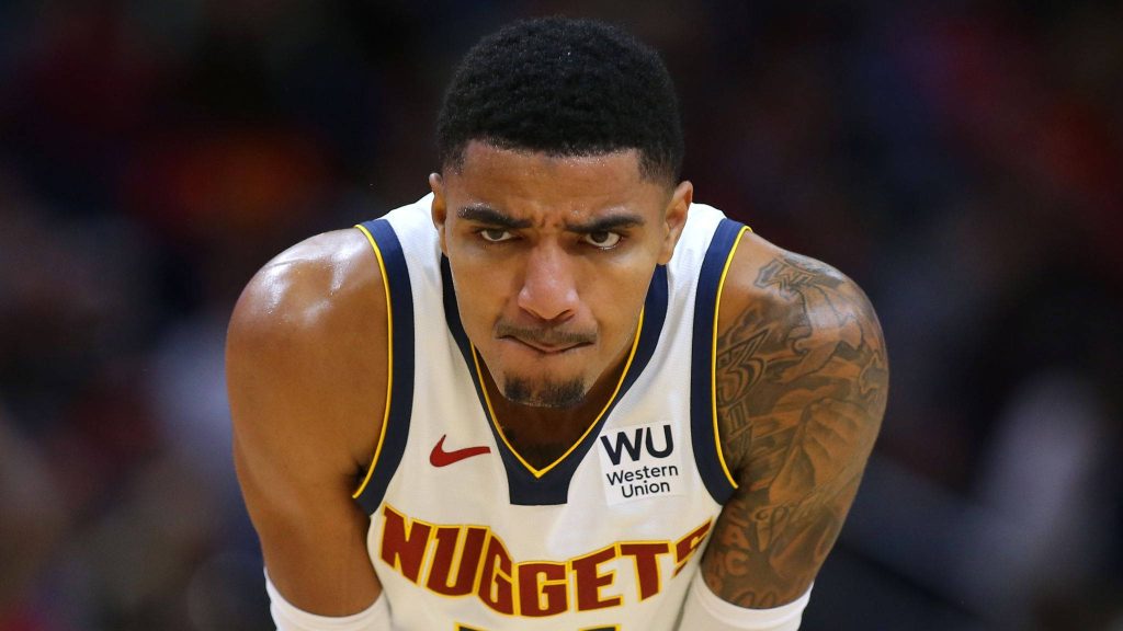 Close-up of NBA guard Gary Harris in Denver Nuggets jersey showing intense focus and shoulder tattoo Wallpaper