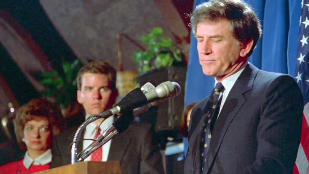 Gary Hart 1980s presidential campaign press conference with American flag background wallpaper