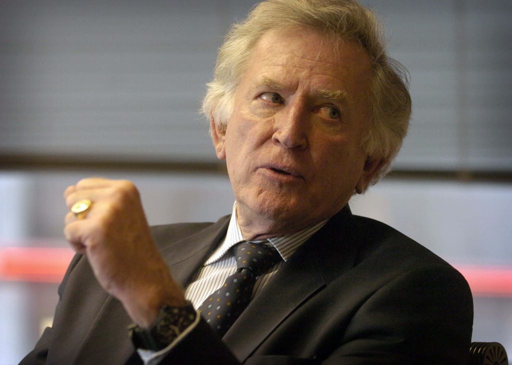 Portrait of former US Senator Gary Hart in dark suit with gold ring and serious expression Wallpaper